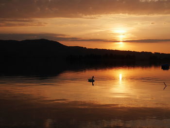 Scenic view of lake against sky during sunset