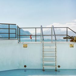 Steps of swimming pool with mountain range in background