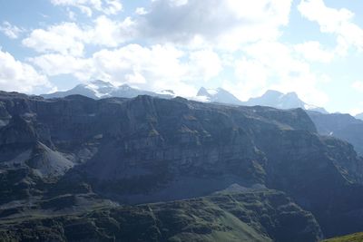 Scenic view of mountains against cloudy sky