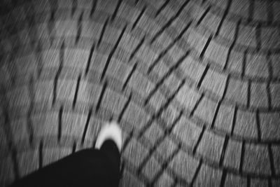 Low section of woman standing on tiled floor