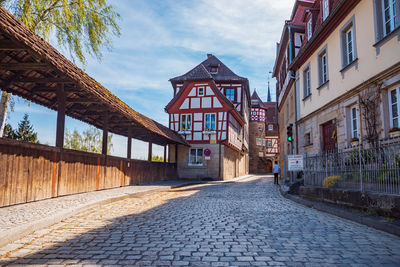 Street amidst buildings against sky