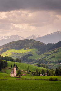 Scenic view of field and mountains against sky