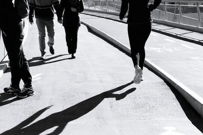 Low section of people walking on zebra crossing