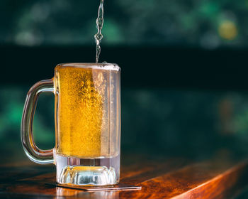 Close-up of beer glass on table