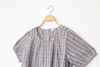 Close-up of clothes hanging over white background