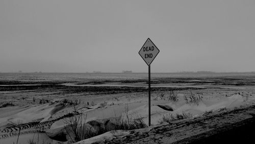 Dead end sign post on landscape