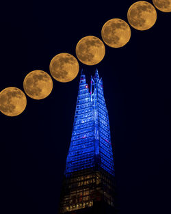 Low angle view of illuminated lights against sky at night