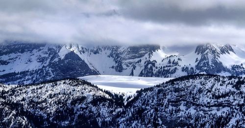 Scenic view of snow covered mountains against sky