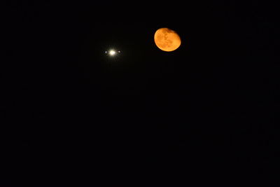 Low angle view of moon against clear sky at night