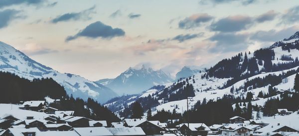 Scenic view of snow covered mountains against sky