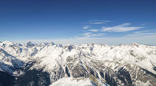 Mountains in snow and sky with clouds