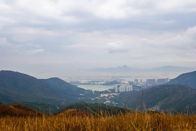 Scenic view of mountains against cloudy sky