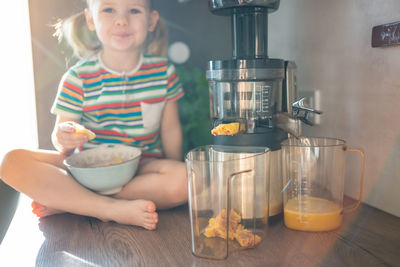 Portrait of cute girl holding food on table