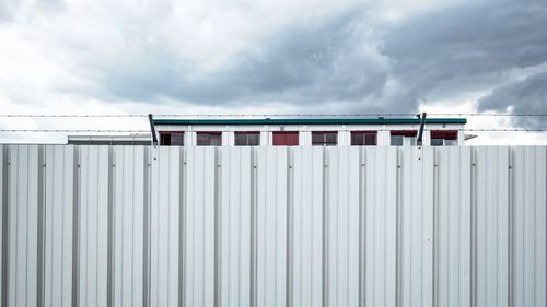 View of factory against cloudy sky