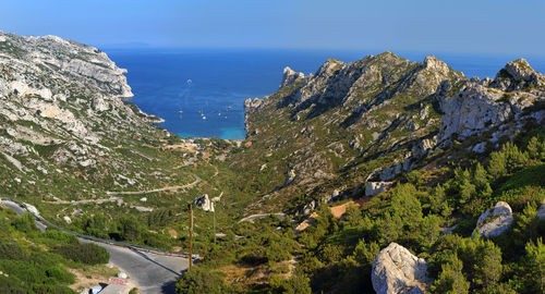 Panoramic shot of road by sea against sky