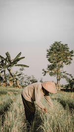 Man working on field against sky