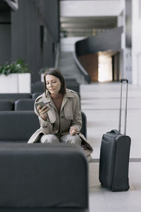 Portrait of young woman sitting on chair