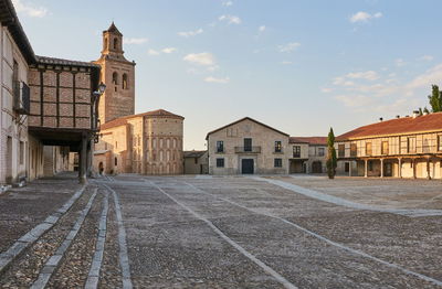 Street amidst buildings against sky in city