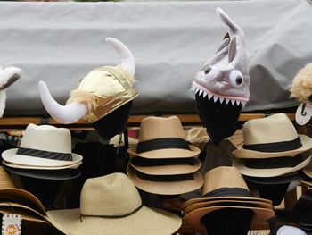 Close-up of hats arranged at market stall