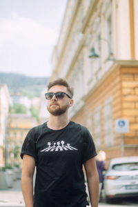 Young man wearing sunglasses standing outdoors