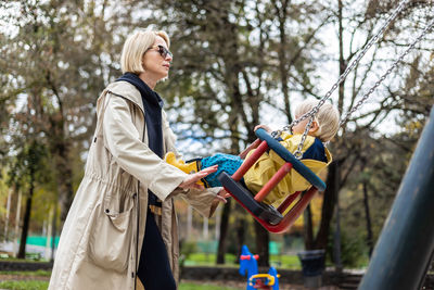 Rear view of woman standing in park