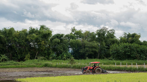 Tractor on field against sky