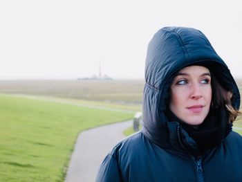 Beautiful woman standing on footpath during winter