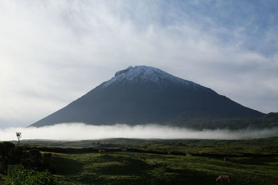 View of volcanic landscape against cloudy sky