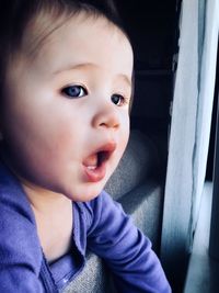 Close-up of cute baby boy sitting in car