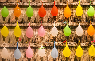 Full frame shot of multi colored balloons hanging on wall