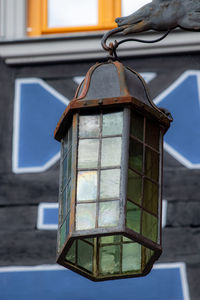 Low angle view of lantern hanging on building