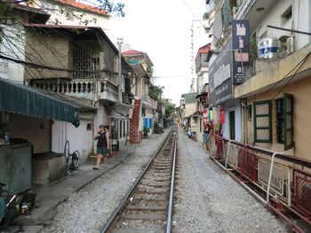 Railroad track amidst buildings against clear sky