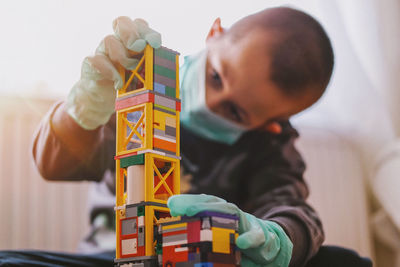 Boy playing with toy at home