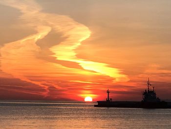 Scenic view of sea against orange sky