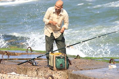 Full length of man standing at sea shore