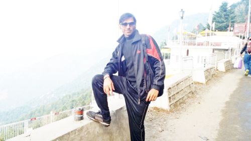 Portrait of young man standing on mountain