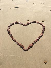 High angle view of heart shape on sand