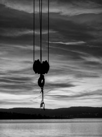 Close-up of swing hanging against sky