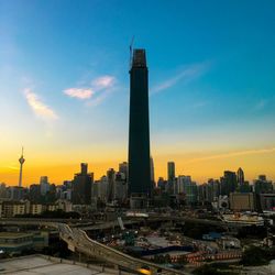 Modern buildings in city at sunset