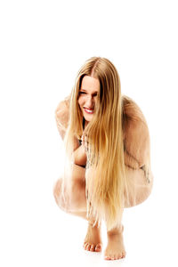 Portrait of smiling young woman against white background