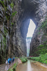 Rear view of people on rock formation