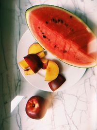 High angle view of chopped fruits in plate on table