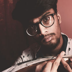 Close-up portrait of young man wearing eyeglasses