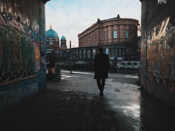 Silhouette of woman standing in city