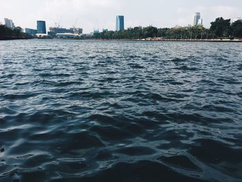 Scenic view of sea against sky in city