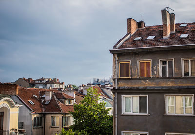 Low angle view of buildings in town against sky