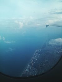 Aerial view of cropped aircraft wing over sea