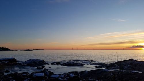 Scenic view of sea against sky during sunset