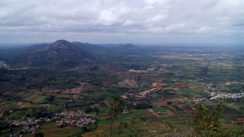 Scenic view of mountains against cloudy sky