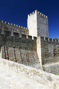 Stone wall against blue sky